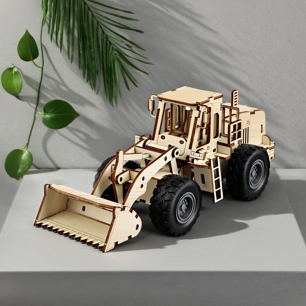 An assembled 3D wooden mechanical wheel loader displayed as a sophisticated home decor piece on a grey stone surface with shadows of green leaves.