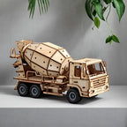 The completed Dilruo 3D wooden cement mixer truck displayed as a sophisticated desk ornament in a modern home setting with natural greenery.