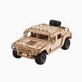 A finished 3D wooden puzzle model of a rugged off-road military truck, resembling a Hummer H1, featuring chunky black tires, a roof rack with lights, and a spare tire mounted on the back, set against a plain light gray background.