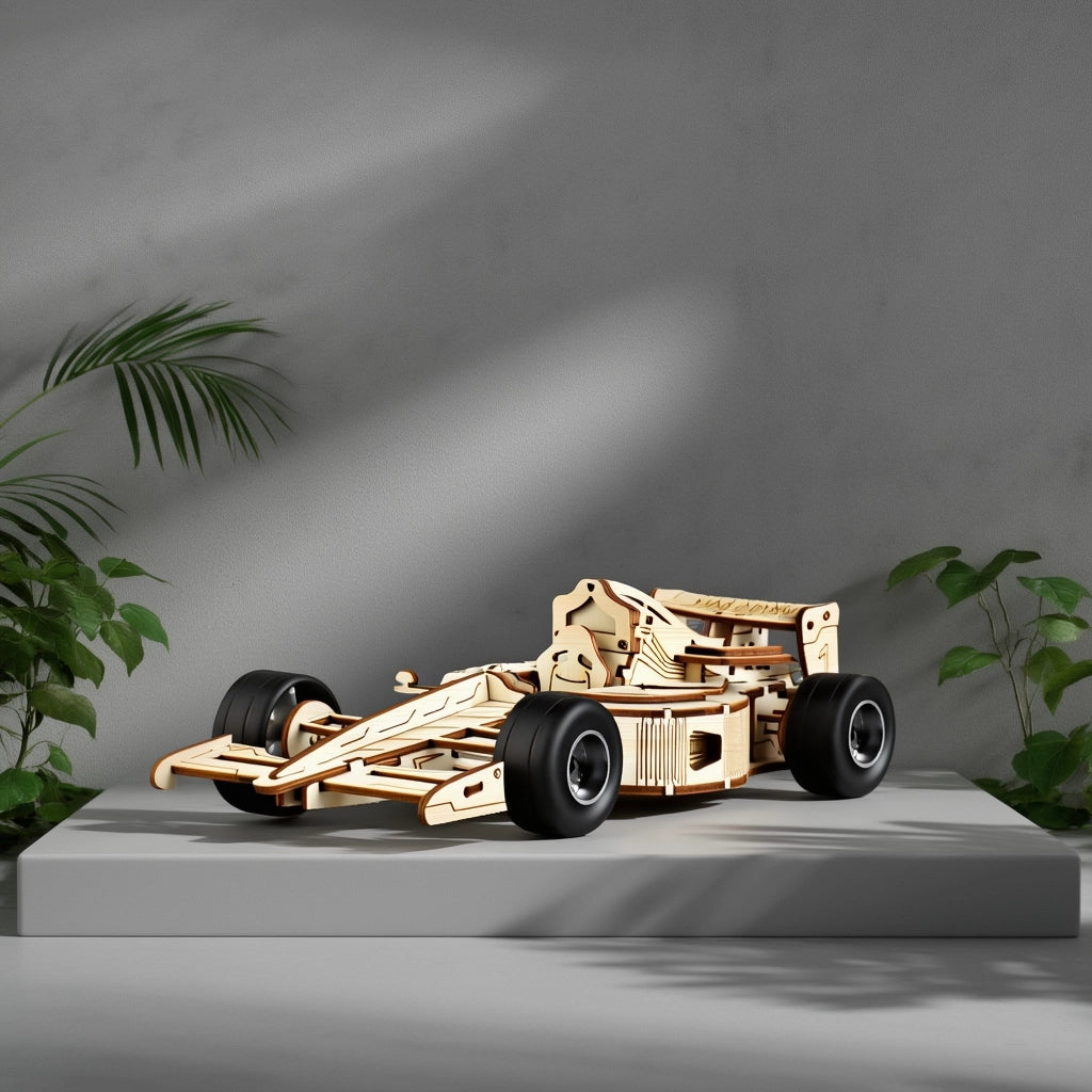 A completed 3D wooden F1 racing car model displayed as elegant desk decor on a modern grey pedestal with green plants.