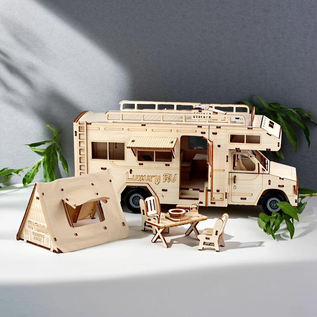 Completed 3D wooden RV puzzle with miniature tent and picnic set as home office decoration.